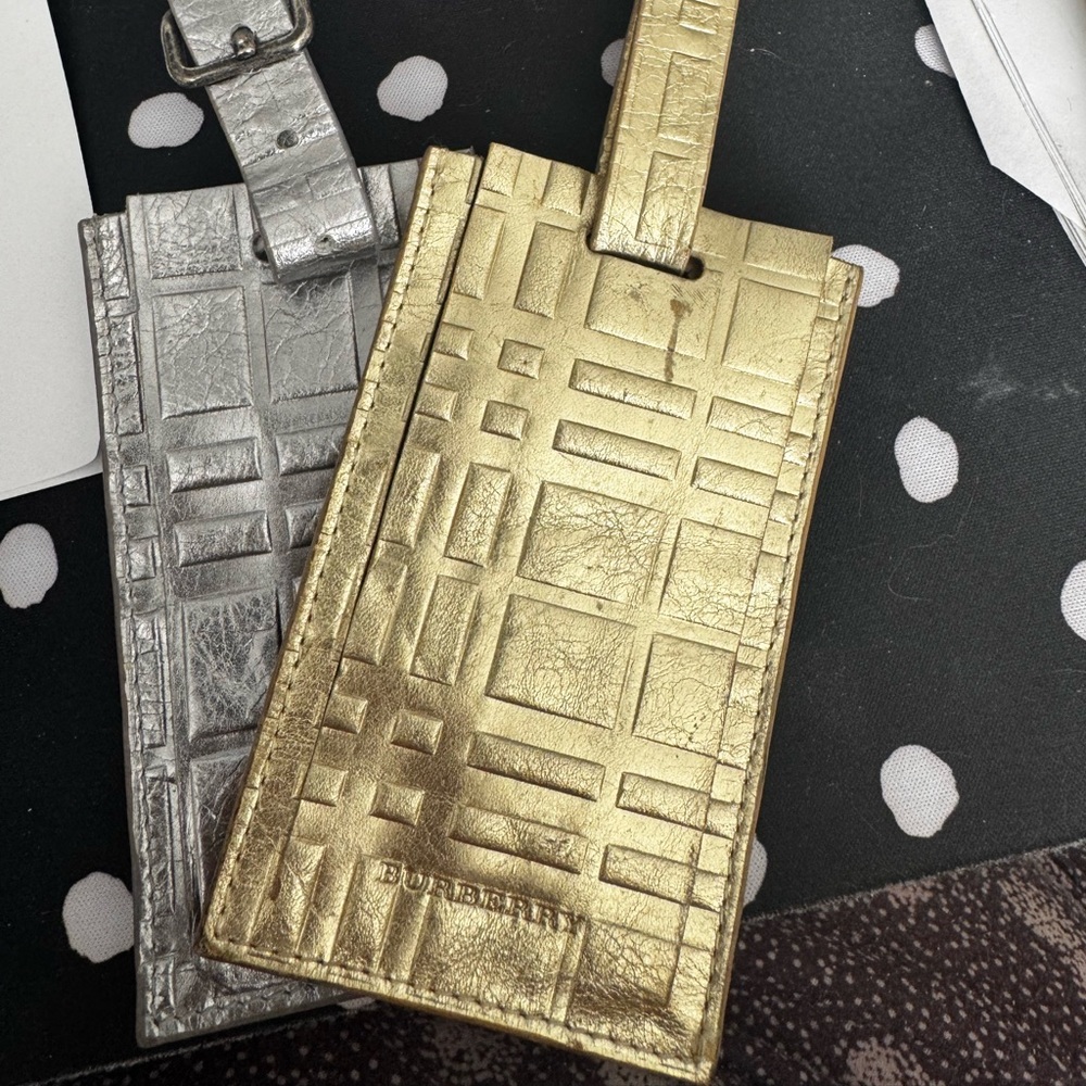 2 Burberry luggage tags unused condition. Gold and silver er in color